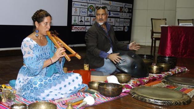 From left) Michelle Button, a sound healing specialist from Mexico, and Sanj Hall, a travelling yogi from UK, demonstrating the sound therapy at NIPER in Mohali on Saturday.(Anil Dayal/Hindustan Times)