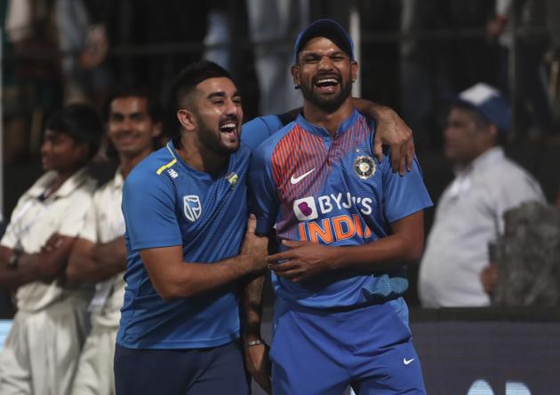 South Africa's Tabraiz Shamsi, left, shares a light moment with India's Shikhar Dhawan. (AP)
