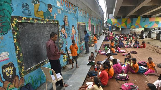 Students study in a school under the metro bridge in Delhi. (Representational image)(Sushil Kumar/HT PHOTO)
