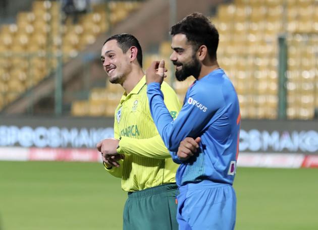 India's captain Virat Kohli and South Africa's captain Quinton de Kock share a light moment during the presentation ceremony. (AP)