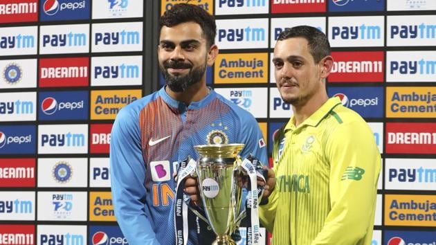 India's captain Virat Kohl and South Africa's captain Quinton de Kock hold the winners trophy after the third and last T20 cricket match. (AP)