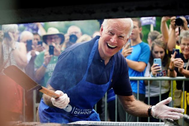 Joe Biden, former U.S. vice president and Democratic presidential hopeful, leans down and smiles for the media while frying steaks at the Polk County Democrats' Steak Fry in Des Moines, Iowa, U.S.. (REUTERS) Joe Biden, former U.S. vice president and Democratic presidential hopeful, leans down and smiles for the media while frying steaks at the Polk County Democrats' Steak Fry in Des Moines, Iowa, U.S.. (REUTERS)