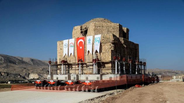 The Artuklu Hamam, a centuries-old bath house, is loaded onto a wheeled platform and moved down a specially constructed road from Hasankeyf to a new location on August 06, 2018. A new Hasankeyf has been built nearby, with some of the old town’s monuments relocated there and brand-new homes for its 3,000 inhabitants. But many find it hard to let go. (Ilyas Akengin / AFP)