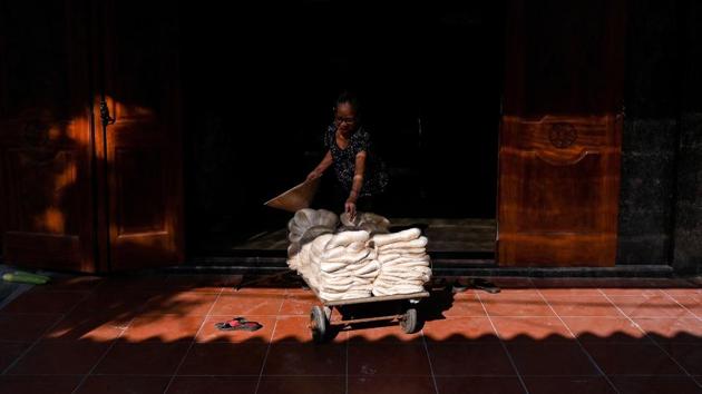 Finished silk threads are wheeled into a storehouse in Co Chat village. Like others in the village, Hien worries about the future of the industry with many youngsters lured by a city lifestyle in nearby Nam Dinh. “My kids tell me this job is too hard,” she said. “They will find other jobs instead.” (Manan Vatsyayana / AFP)