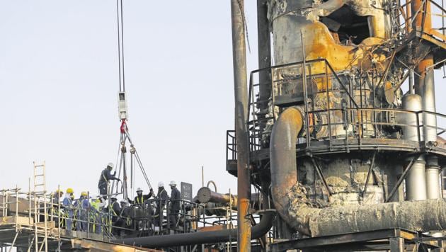 Workers at the damaged site of Saudi Aramco oil facility in Abqaiq, Saudi Arabia on September 20, 2019.(Reuters File Photo)