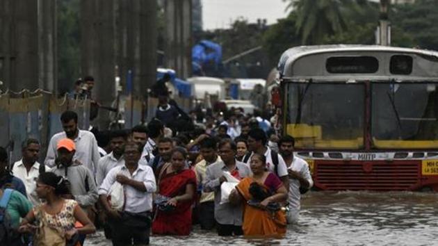 People walk through a flooded street following heavy monsoon rains at LBS road Kurla in Mumbai. (Kunal Patil/HT Photo) People walk through a flooded street following heavy monsoon rains at LBS road Kurla in Mumbai. (Kunal Patil/HT Photo)