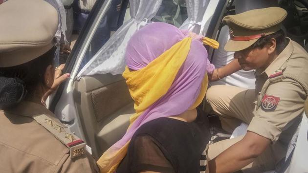 The woman law student (face covered), who alleged BJP leader Chinmayanand of sexual misconduct and harassment, arrested by the Special Investigation Team (SIT) a day after she was detained for questioning in an extortion case, in Shahjahanpur, Wednesday, Sept. 25, 2019. (PTI) The woman law student (face covered), who alleged BJP leader Chinmayanand of sexual misconduct and harassment, arrested by the Special Investigation Team (SIT) a day after she was detained for questioning in an extortion case, in Shahjahanpur, Wednesday, Sept. 25, 2019. (PTI)