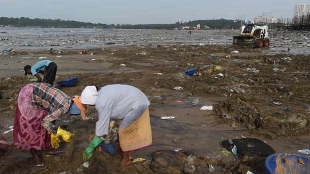 City civil authority workers pick up plastic waste and trash during a clean-up drive on Versova beach. Mumbai is already vulnerable to floods because so much of it is below the high-tide line. The shore has retreated by more than 20-mtrs at some beaches over the past 15 years, according to studies by the Watchdog Foundation activist group. Floodwaters already overwhelm Mumbai every monsoon. (Punit Paranjpe / AFP) City civil authority workers pick up plastic waste and trash during a clean-up drive on Versova beach. Mumbai is already vulnerable to floods because so much of it is below the high-tide line. The shore has retreated by more than 20-mtrs at some beaches over the past 15 years, according to studies by the Watchdog Foundation activist group. Floodwaters already overwhelm Mumbai every monsoon. (Punit Paranjpe / AFP)