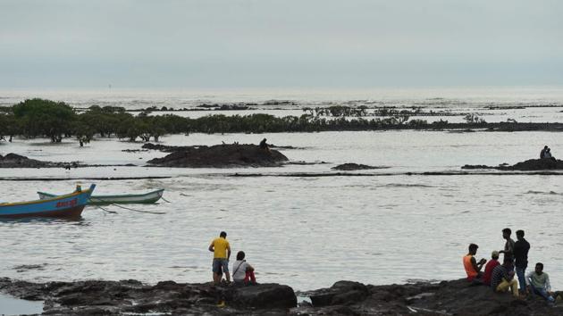 People sit on rocks next to mangroves on the coast during low tide in Mumbai. The Maharashtra state government’s response has concentrated on building 20 sea walls -- including four off Mumbai -- and a huge mangrove planting campaign along the state’s 720-km coast. Offshore reefs and beach restoration plans are also being considered. (Indranil Mukherjee / AFP) People sit on rocks next to mangroves on the coast during low tide in Mumbai. The Maharashtra state government’s response has concentrated on building 20 sea walls -- including four off Mumbai -- and a huge mangrove planting campaign along the state’s 720-km coast. Offshore reefs and beach restoration plans are also being considered. (Indranil Mukherjee / AFP)