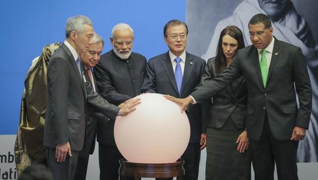 Singapore PM Lee Hsien Loong, from left to right, Bangladesh PM Sheikh Hasina, United Nations Secretary-General Antonio Guterres, PM Narendra Modi, South Korea President Moon Jae-in, New Zealand PM Jacinda Ardern and Jamaica's PM Andrew Holness place hands on a light ball symbolizing earth for a special event commemorating the 150th anniversary of Mahatma Gandhi, during the United Nations General Assembly, Tuesday.(AP photo)
