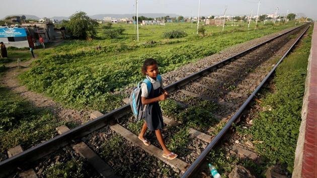 Sakshi Garud crosses the railway tracks at Mukundwadi railway station on her way to school, in Aurangabad. While their classmates set off to play after school each day, nine-year-old Sakshi Garud and her neighbour Siddharth Dhage, 10, are among a small group of children who take a 14-km return train journey from their village in Maharashtra to fetch water. (Francis Mascarenhas / REUTERS) Sakshi Garud crosses the railway tracks at Mukundwadi railway station on her way to school, in Aurangabad. While their classmates set off to play after school each day, nine-year-old Sakshi Garud and her neighbour Siddharth Dhage, 10, are among a small group of children who take a 14-km return train journey from their village in Maharashtra to fetch water. (Francis Mascarenhas / REUTERS)