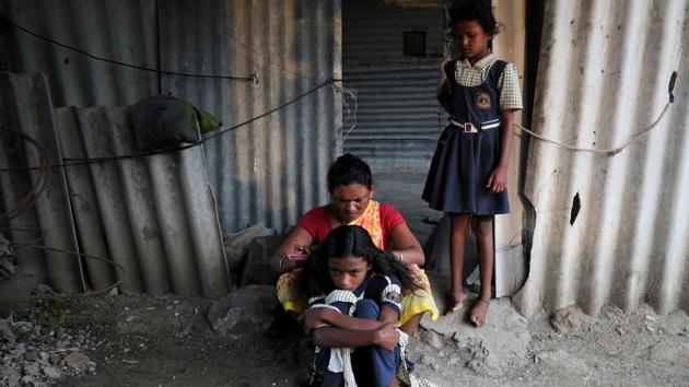 Sakshi Garud looks on as her mother Swati, ties her sister Aaysha's hair, as she gets ready to go to school. Garud and Dhage’s families are some of the poorest in the hamlet of Mukundwadi,, a village that has suffered back-to-back droughts. “This is my daily routine,” said Garud. “After coming from school, I don’t get time to play. I need to get water first.” (Francis Mascarenhas / REUTERS) Sakshi Garud looks on as her mother Swati, ties her sister Aaysha's hair, as she gets ready to go to school. Garud and Dhage’s families are some of the poorest in the hamlet of Mukundwadi,, a village that has suffered back-to-back droughts. “This is my daily routine,” said Garud. “After coming from school, I don’t get time to play. I need to get water first.” (Francis Mascarenhas / REUTERS)