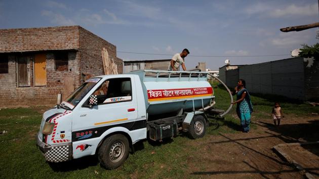 A woman takes hold of a pipe from a water tanker in Aurangabad. More than 100 families in Garud and Dhage’s neighbourhood do not have access to piped water and many depend on private water suppliers, who charge up to 3,000 rupees ($42) for a 5,000-litre tanker during summer months. (Francis Mascarenhas / REUTERS) A woman takes hold of a pipe from a water tanker in Aurangabad. More than 100 families in Garud and Dhage’s neighbourhood do not have access to piped water and many depend on private water suppliers, who charge up to 3,000 rupees ($42) for a 5,000-litre tanker during summer months. (Francis Mascarenhas / REUTERS)