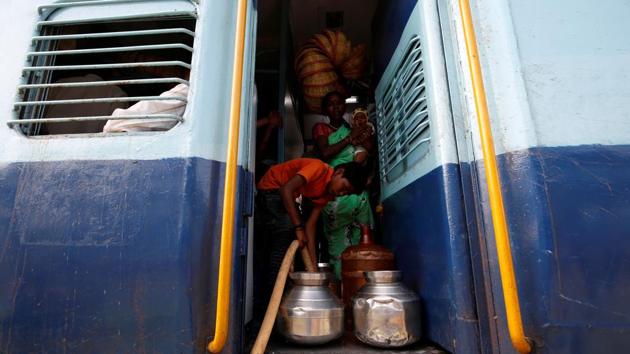 Siddharth’s mother Jyoti watches her neighbour Gaurav Ganesh, 13, as he helps fill the containers with water. When the train pulls into Aurangabad thirty minutes later, they scramble to fill the pitchers at nearby water pipes. Garud can’t reach the tap, so she relies on her taller sister, Aaysha, 14, and grandmother. (Francis Mascarenhas / REUTERS) Siddharth’s mother Jyoti watches her neighbour Gaurav Ganesh, 13, as he helps fill the containers with water. When the train pulls into Aurangabad thirty minutes later, they scramble to fill the pitchers at nearby water pipes. Garud can’t reach the tap, so she relies on her taller sister, Aaysha, 14, and grandmother. (Francis Mascarenhas / REUTERS)