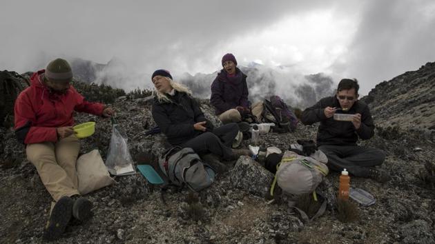 A lunch break. Within a few years or decades, bacteria and lichen colonize the area. As they decompose the minerals and decay themselves into organic matter, the first hints of soil form, the basis of a new ecosystem, providing a structure to retain water and for plant roots to grow. “The formation of soil is the difference between an ecosystem being able to form quickly and being stalled for hundreds of years,” Llambí said. (Rodrigo Abd / AP) A lunch break. Within a few years or decades, bacteria and lichen colonize the area. As they decompose the minerals and decay themselves into organic matter, the first hints of soil form, the basis of a new ecosystem, providing a structure to retain water and for plant roots to grow. “The formation of soil is the difference between an ecosystem being able to form quickly and being stalled for hundreds of years,” Llambí said. (Rodrigo Abd / AP)