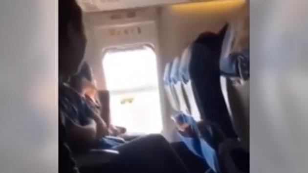 Her co-passengers warned her not to open the emergency exit of the plane.(YouTube/Awesome Gary) Her co-passengers warned her not to open the emergency exit of the plane.(YouTube/Awesome Gary)