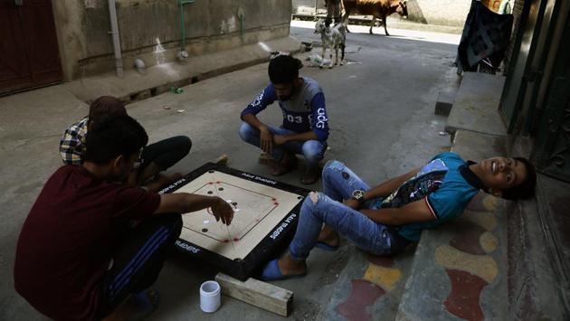 Children play carom board at a closed market area in Srinagar. Another former chief minister and sitting Lok Sabha MP from Srinagar Farooq Abdullah has been arrested under the controversial Public Safety Act, a law enacted by his father and National Conference founder Sheikh Mohammad Abdullah in 1978 when he was the chief minister. (Mukhtar Khan / AP) Children play carom board at a closed market area in Srinagar. Another former chief minister and sitting Lok Sabha MP from Srinagar Farooq Abdullah has been arrested under the controversial Public Safety Act, a law enacted by his father and National Conference founder Sheikh Mohammad Abdullah in 1978 when he was the chief minister. (Mukhtar Khan / AP)