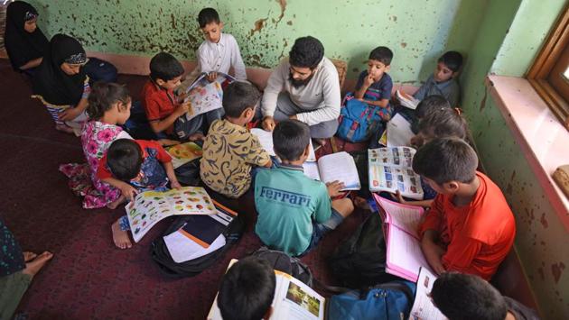 Children study at the residence of a tuition teacher in the outskirts of Srinagar. Children have instead found refuge in makeshift schools amid the lockdown as dozens of ad hoc learning centres have popped up in homes and religious centres, and hundreds of students have signed up. (Waseem Andrabi / HT Photo) Children study at the residence of a tuition teacher in the outskirts of Srinagar. Children have instead found refuge in makeshift schools amid the lockdown as dozens of ad hoc learning centres have popped up in homes and religious centres, and hundreds of students have signed up. (Waseem Andrabi / HT Photo)