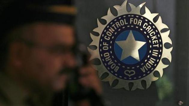 A policeman walks past a logo of the Board of Control for Cricket in India (BCCI).(REUTERS) A policeman walks past a logo of the Board of Control for Cricket in India (BCCI).(REUTERS)