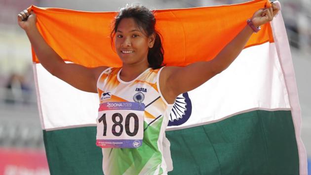 India's Swapna Barman celebrates with national flag after competing in the women's heptathlon.(AP)