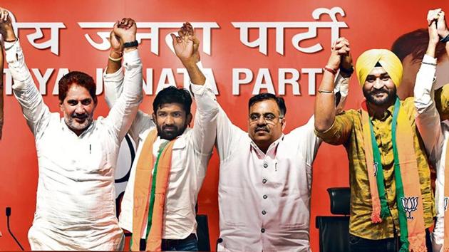 Indian wrestler Yogeshwar Dutt (second from left) and former Indian hockey captain Sandeep Singh (right) joined the BJP in the presence of Haryana state unit chief Subash Barala (left) in New Delhi on Thursday.