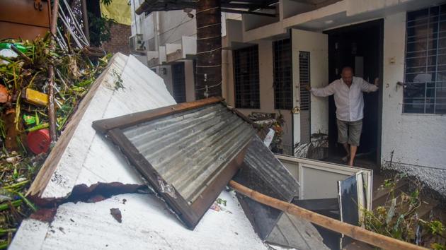 A man looks out of his house at a collapsed wall near Tangewale colony, after flash floods in Pune, on September 26. There was relief on Thursday due to clear skies and all attention is now shifted to clearing garbage, debris and restoring normalcy in the worst-hit areas. (Sanket Wankhade / HT Photo) A man looks out of his house at a collapsed wall near Tangewale colony, after flash floods in Pune, on September 26. There was relief on Thursday due to clear skies and all attention is now shifted to clearing garbage, debris and restoring normalcy in the worst-hit areas. (Sanket Wankhade / HT Photo)