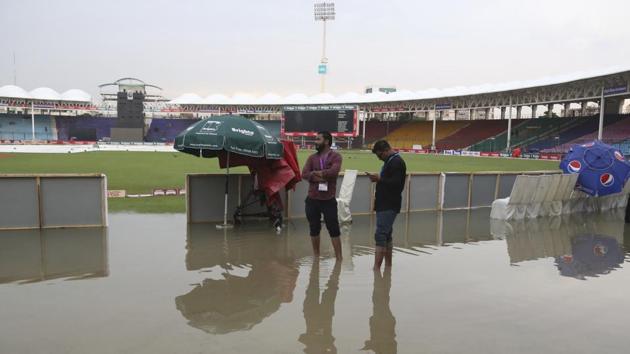 Officials stand at the National Stadium after rain in Karachi, Pakistan. (AP) Officials stand at the National Stadium after rain in Karachi, Pakistan. (AP)