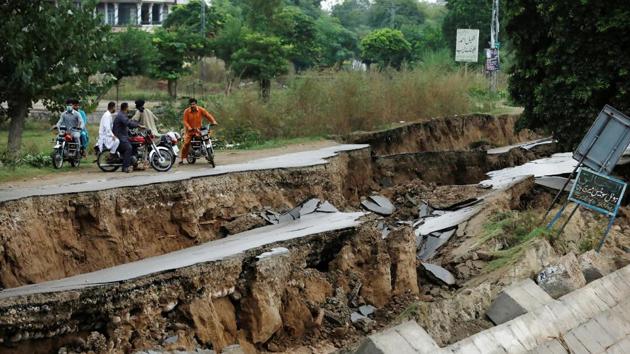 People on bikes gather near a damaged road after an earthquake in Mirpur, Pakistan. (Akhtar Soomro / REUTERS) People on bikes gather near a damaged road after an earthquake in Mirpur, Pakistan. (Akhtar Soomro / REUTERS)