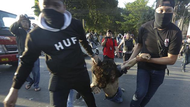 Plainclothes police officers arrest a student protester during a rally in Makassar, South Sulawesi province, Indonesia. (Bahauddin Raja Baso / AP) Plainclothes police officers arrest a student protester during a rally in Makassar, South Sulawesi province, Indonesia. (Bahauddin Raja Baso / AP)