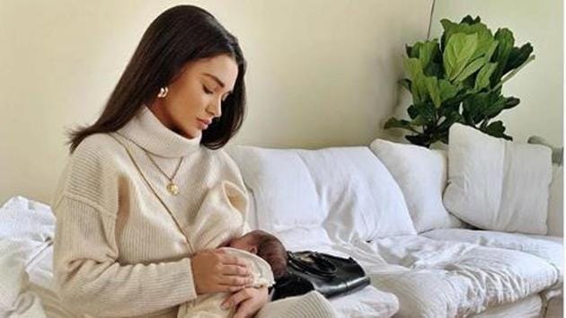 Amy Jackson feeds her baby.