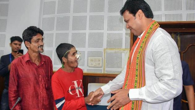 Tripura Chief Minister Biplab Kumar Deb interacts with Mijanur Rehman from Sonamura, in Agartala, Tripura. Rehman, who was bedridden for past seven years, was helped by local party workers to make an Ayushman Bharat Card through which he has been able to undergo treatment in NIMHANS Bangalore. (PTI) Tripura Chief Minister Biplab Kumar Deb interacts with Mijanur Rehman from Sonamura, in Agartala, Tripura. Rehman, who was bedridden for past seven years, was helped by local party workers to make an Ayushman Bharat Card through which he has been able to undergo treatment in NIMHANS Bangalore. (PTI)