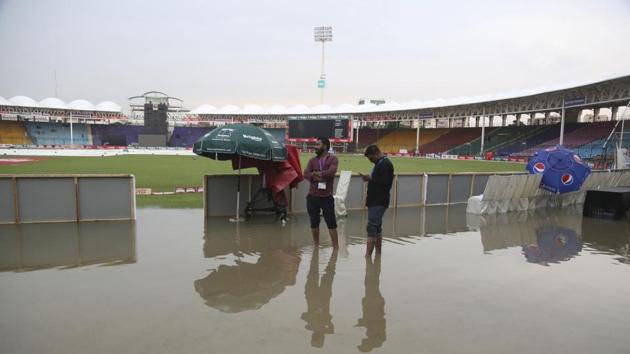 Officials stand at the National Stadium after rain in Karachi, Pakistan, Friday, Sept. 27, 219. Heavy rain has delayed the start of the first one-day international between Pakistan and Sri Lanka. An unusual spell of rain in the southern port city of Karachi during this time of the year left the cricket ground completely waterlogged on Friday.(AP)