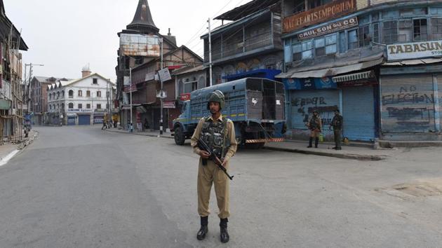 A paramilitary soldier stands guard on an empty road during restrictions, at Lal Chowk, in Srinagar, Jammu and Kashmir.(HT Photo) A paramilitary soldier stands guard on an empty road during restrictions, at Lal Chowk, in Srinagar, Jammu and Kashmir.(HT Photo)