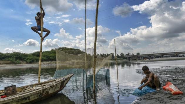 Fishermen prepare to cast their net in the Yamuna river, in New Delhi. (Arun Sharma / PTI) Fishermen prepare to cast their net in the Yamuna river, in New Delhi. (Arun Sharma / PTI)
