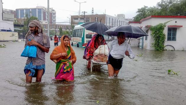 Patients wade through floodwaters on their way to hospital during heavy monsoon rain in Patna, Bihar. (Sachin Kumar / AFP) Patients wade through floodwaters on their way to hospital during heavy monsoon rain in Patna, Bihar. (Sachin Kumar / AFP)