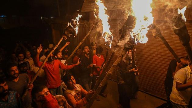 Youths take part in a torch-protest march against abrogation of Article 370 and reorganisation of the Jammu and Kashmir state into two Union Territories, in Srinagar, Jammu and Kashmir. (S. Irfan / PTI) Youths take part in a torch-protest march against abrogation of Article 370 and reorganisation of the Jammu and Kashmir state into two Union Territories, in Srinagar, Jammu and Kashmir. (S. Irfan / PTI)