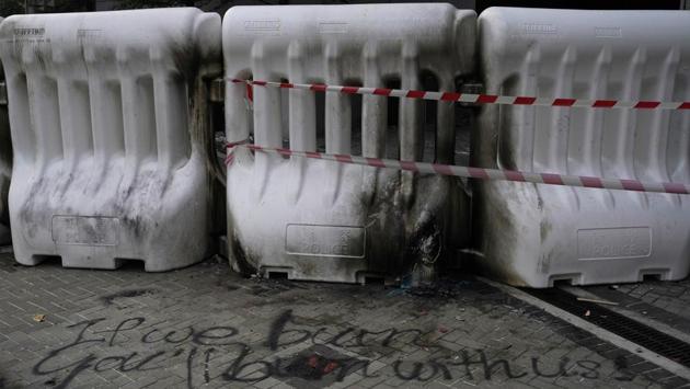 Burn marks from homemade gasoline bombs and burned rubbish scar the streets and plastic road barriers. An ominous quote "If we burn, you'll burn with us" from the movie "Hunger Games: Mockingjay" is scribbled in front of plastic barriers which were burned after protesters threw Molotov cocktail in front of the government headquarters. (Vincent Yu / AP) Burn marks from homemade gasoline bombs and burned rubbish scar the streets and plastic road barriers. An ominous quote "If we burn, you'll burn with us" from the movie "Hunger Games: Mockingjay" is scribbled in front of plastic barriers which were burned after protesters threw Molotov cocktail in front of the government headquarters. (Vincent Yu / AP)