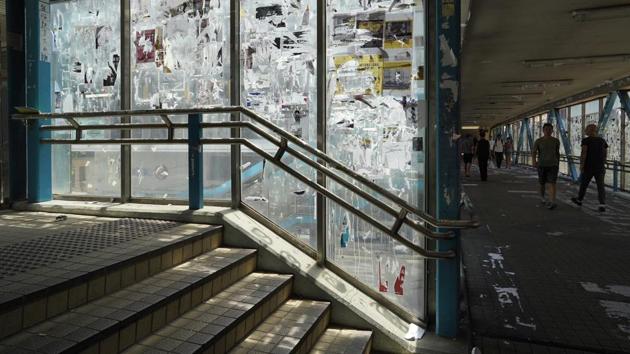 An overpass in Causeway Bay is filled with torn scraps of anti-government posters in Hong Kong. Overpasses are filled with sticky notes and prints of protest art have been scraped with little avail, leaving torn paper scraps everywhere. (Vincent Yu / AP) An overpass in Causeway Bay is filled with torn scraps of anti-government posters in Hong Kong. Overpasses are filled with sticky notes and prints of protest art have been scraped with little avail, leaving torn paper scraps everywhere. (Vincent Yu / AP)