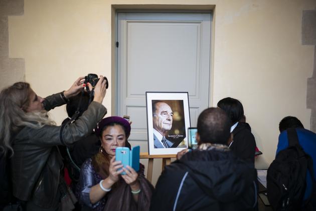 Members of the public take pictures after paying respect to late French President Jacques Chirac, Sunday, Sept. 29, 2019 at the Invalides monument in Paris. Jacques Chirac will lie in state Sunday during a public ceremony at the Invalides monument, where France honors its heroes. A memorial service and private funeral are planned for Monday.(AP) Members of the public take pictures after paying respect to late French President Jacques Chirac, Sunday, Sept. 29, 2019 at the Invalides monument in Paris. Jacques Chirac will lie in state Sunday during a public ceremony at the Invalides monument, where France honors its heroes. A memorial service and private funeral are planned for Monday.(AP)