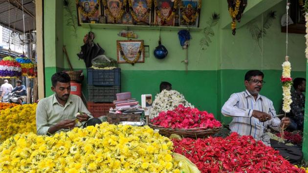 Vendors make garlands at a flowers shop ahead of the festive season. October and November -- when much of the country’s 1.3 billion population celebrates several major festivals and consumers traditionally go on spending sprees -- are critical for retailers, with some raking in almost half of their annual sales during the period. (Noah Seelam / AFP)