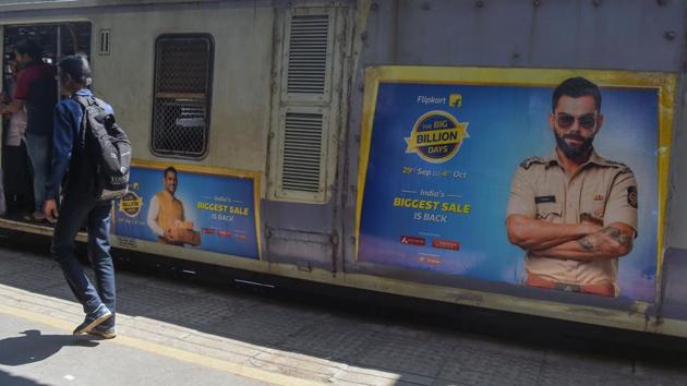 Flipkart has Indian mega-star cricket Virat Kohli as the face of their “Big Billion Days” sales campaign and has slashed prices on fashion items and home appliances. The two platforms -- which have almost 75 percent market share of the e-commerce market -- hope to attract cash-strapped shoppers with financing options, and have hired hundreds of thousands of temporary staff to cope with expected increased demand. (Noah Seelam / AFP)