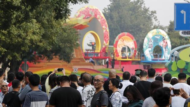 Residents watch a float behind barricade line as Chinese military vehicles and floats in preparation for the parade for the 70th anniversary of the founding of the People’s Republic of China, in Beijing, Tuesday, Oct. 1, 2019. Tuesday’s event marks the anniversary of the Oct. 1, 1949, announcement of the founding of the People’s Republic of China by then-leader Mao Zedong following a civil war.(AP)