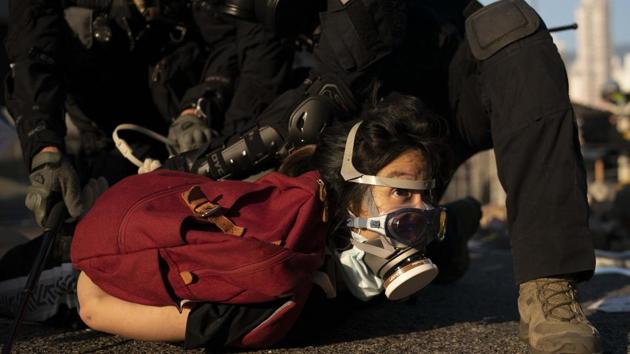 Police detain an anti-government protester in Hong Kong. On Wednesday, hundreds of Hong Kongers staged a sit-in outside the school of Tsang Chi-kin, an 18-year-old protester who was shot by the police. Police said the officer feared for his life on a day that saw his colleagues fire five warning shots from their pistols throughout the city. “In this very short span of time, he made a decision and shot the assailant,” police chief Stephen Lo said. (AP)