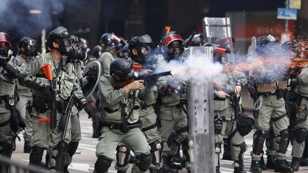 Police fire tear gas to disperse anti-government protesters in Hong Kong. Police said 25 officers were injured in the National Day clashes, including some who suffered chemical burns from a corrosive liquid that was thrown at them by protesters. The liquid also wounded some journalists. (AP)