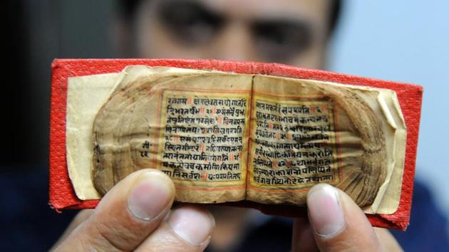Mritunjay Kumar, Archivist showing Miniature “Shrimad Bhagwad Gita” Historical books (HT File)