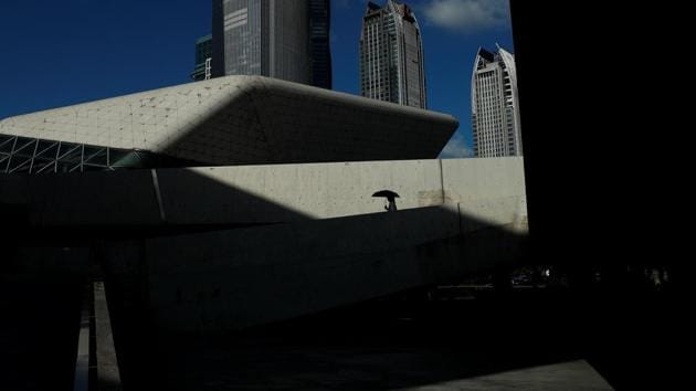 A woman holds an umbrella as she walks outside the Opera House in Guanghzou. The city is at the heart of plans to link a cluster of cities in the Pearl River Delta, including Hong Kong and Macau, into a Greater Bay Area rivalling Silicon Valley and Greater Tokyo as an economic hub by 2035. (Jorge Silva / REUTERS)