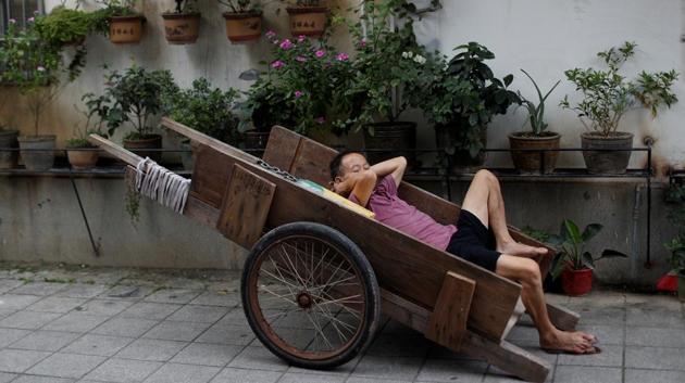 A man sleeps in a cart near a market in Yuexiu. As rising labour costs and competition across Asia chip away at south China’s manufacturing advantage, the ruling Communist Party hopes its drive for more advanced production and research will push the Greater Bay Area towards new wealth. The area has a combined gross domestic product of about $1.5 trillion, roughly equivalent to that of Australia or South Korea. (Jorge Silva / REUTERS)