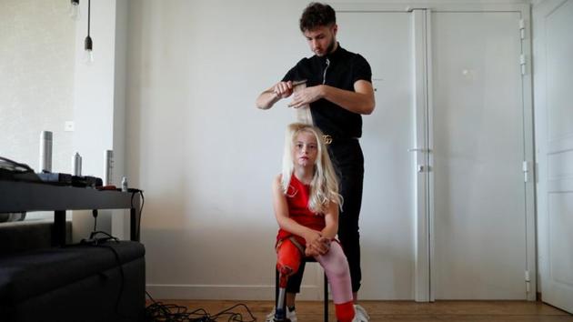 Demetre gets her hair done a day before the show. “Here to make history, that’s what we do,” she said on her Instagram account, which showed a picture of Daisy-May and her father Alex in front of the Eiffel Tower. (Gonzalo Fuentes / REUTERS)