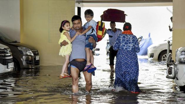 A man, carrying children from school, wades through flood-water in Rajendra Nagar area of Patna. (Photo: PTI) A man, carrying children from school, wades through flood-water in Rajendra Nagar area of Patna. (Photo: PTI)