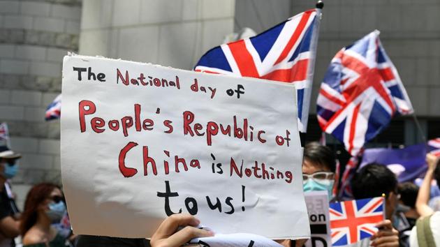A group of people call on Britain to put pressure on Beijing during a protest outside the British consulate in Hong Kong. Former colonial ruler Britain, who handed Hong Kong back to China in 1997, decried the use of live ammunition as “disproportionate”. Foreign Secretary Dominic Raab said that “it only risks inflaming the situation”. (Mohd Rasfan / AFP)